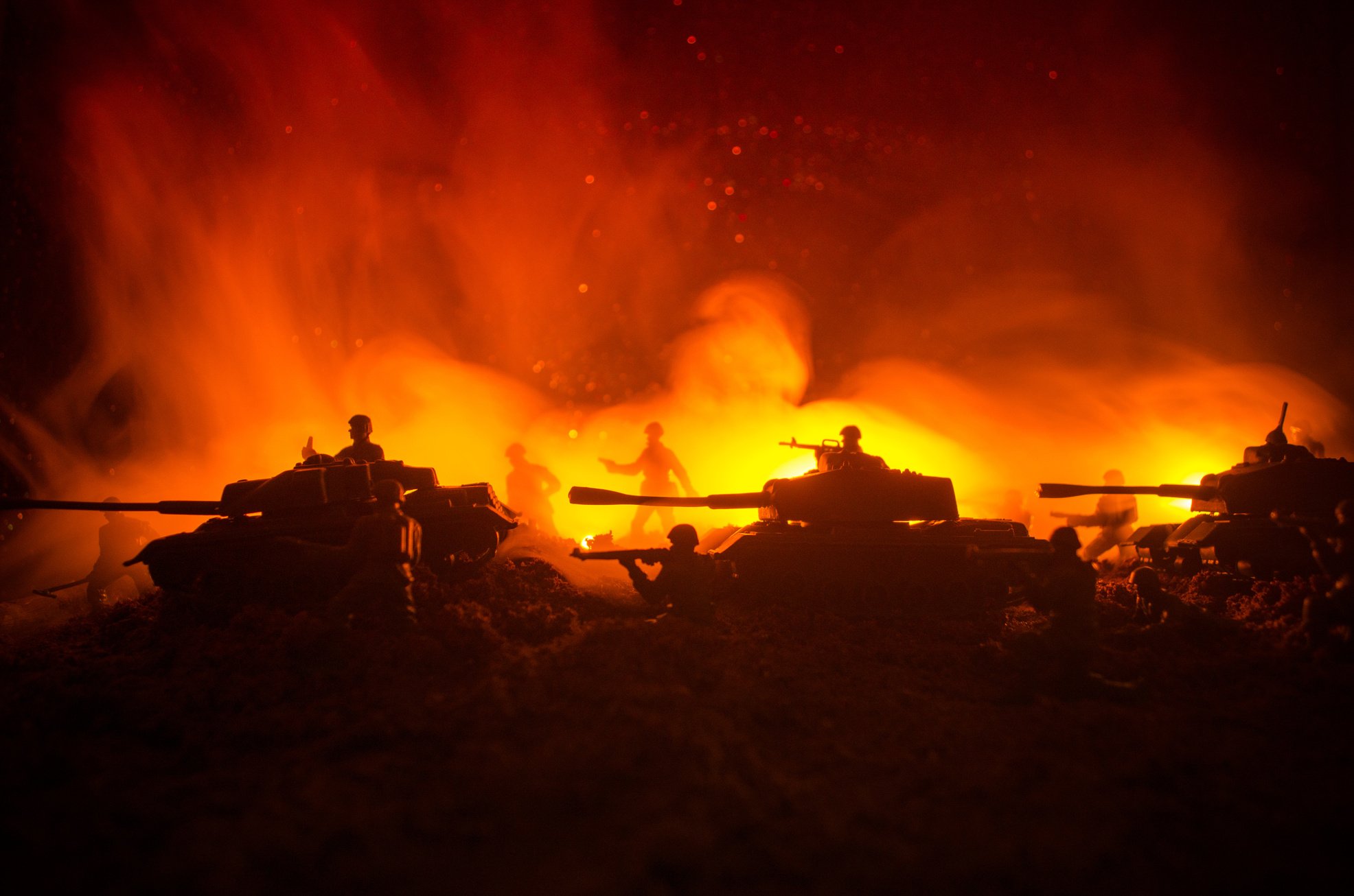 War Concept. Military silhouettes fighting scene on war fog sky background, World War Soldiers Silhouettes Below Cloudy Skyline At night. Attack scene. Armored vehicles.